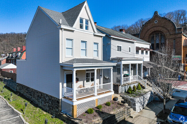 Some houses in the Millvale neighborhood have porches to relax and enjoy the sun.