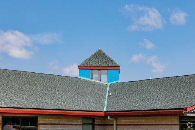 A distinctive skylight forms the roofline of the Ozark Middle School building.