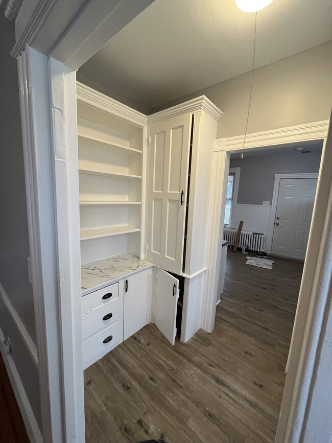 Butler Pantry between Kitchen and dining room. Plenty of cabinetry and shelving.