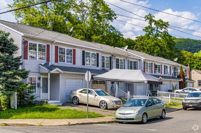 Discover the charm of living in cozy townhomes tucked away in the hills of Highlands.