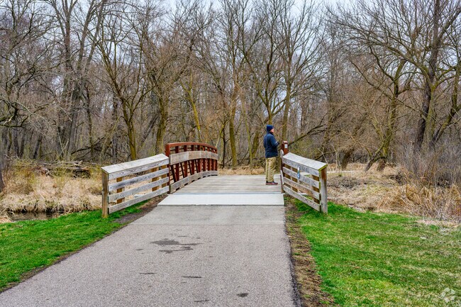 A visitor to Albert A. White Memorial Park, enjoys a quiet moment beside the park's pond.