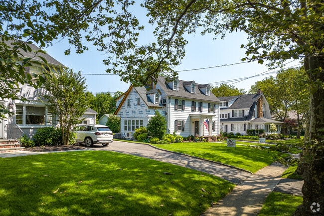 A row of large homes on a shady residential street in Westfield, NJ.