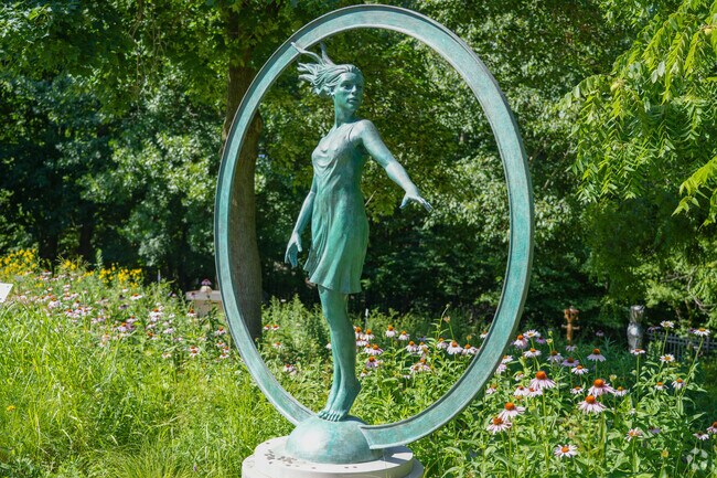 The Haan Sculpture Garden has beautiful sculptures surrounded by beautiful flowers.