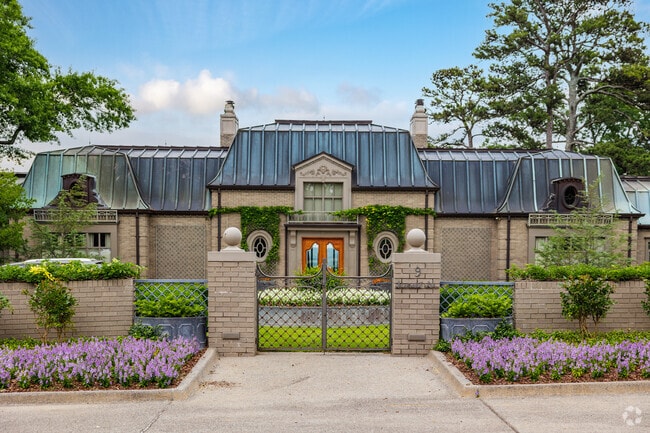 A larger Mansard style home with copper finishes sits comfortably in Cammack Village.