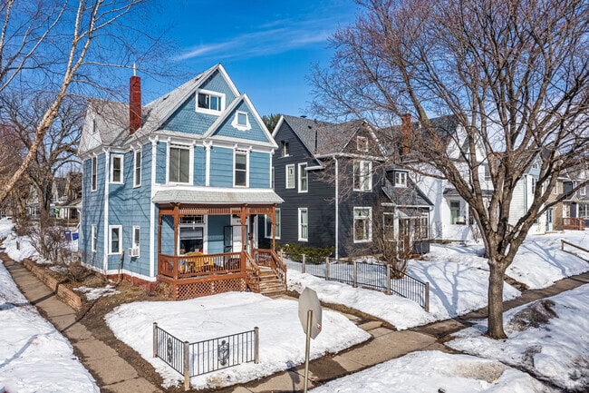 Victorian style homes sit on well-kept lawns.