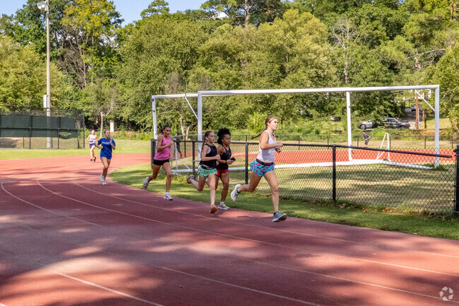 Students practice running drills on the track at Lakebottom Park.