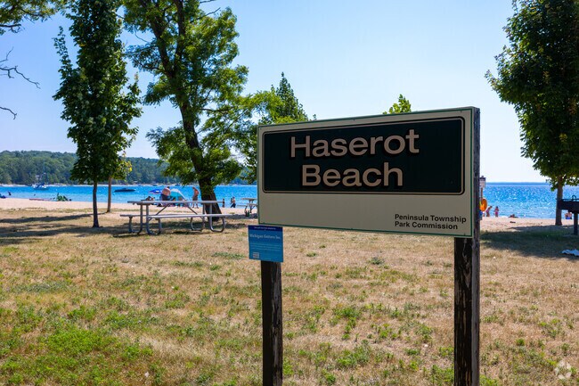 Haserot Beach’s grassy lawn and picnic tables welcome visitors to Grand Traverse Bay.