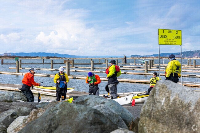Kayakers explore the waters near Jetty Island in Northwest Everett.