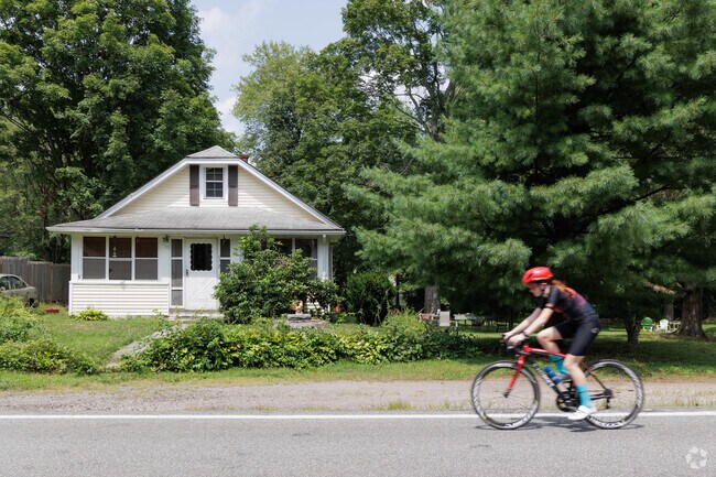 A biker zips by a bungalow in Tuxedo Park, NY