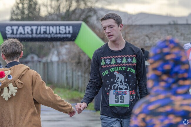 High fives after running through heavy rainfall in the Reindeer Run 5K in Orting.