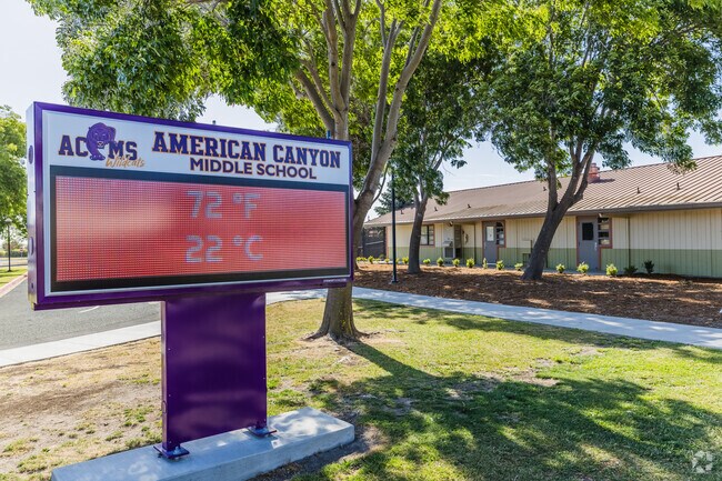 Parents and teachers meet for a conference, collaborating for success at American Canyon Middle