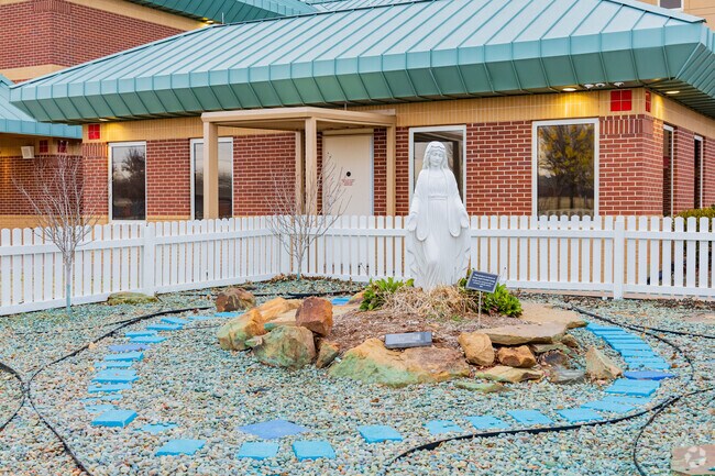 All Saints Catholic School had a statue depicting a religious figure.