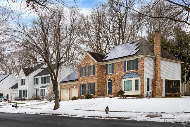 Brick facade Colonial homes in Tall Oaks Crossing beak up the rows of homes.