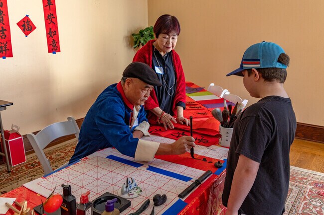 Calligrapher writing the lucky words for Samtee and nearby visitors at the Chinese Lunar New Year Celebration in San Jose.
