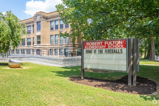 There's a large green open area in front of Fulton Elementary School.