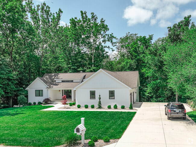A simple ranch home is hugged by   large trees, in Westbrook.