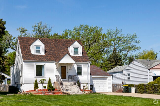 Cape Cod style houses with long driveways give West Grand Ave residents ample yard space.