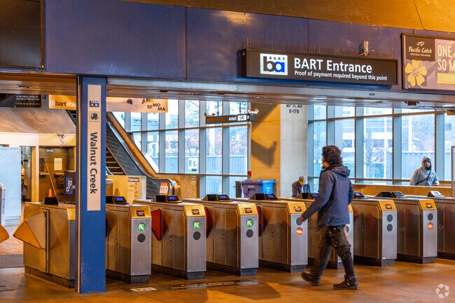 People are entering the BART station at the Walnut Creek entrance.