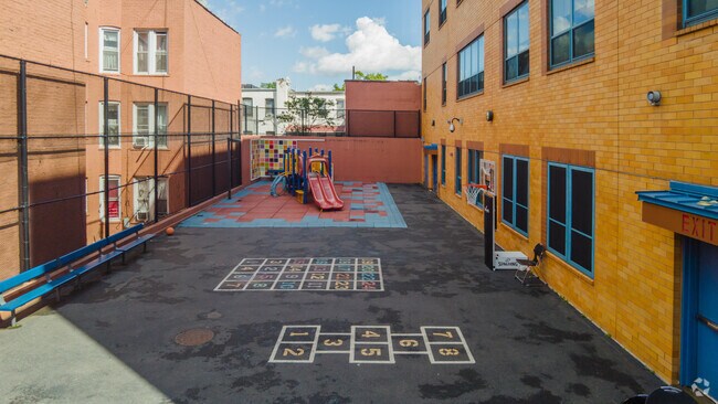 The P.S. 971 school playground has a small play area with some blacktop games.