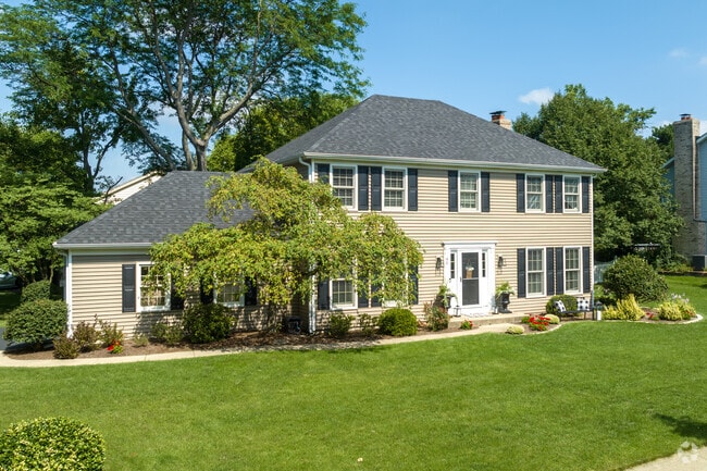 Georgian-style homes with shutters and beige siding sit in North Danada.