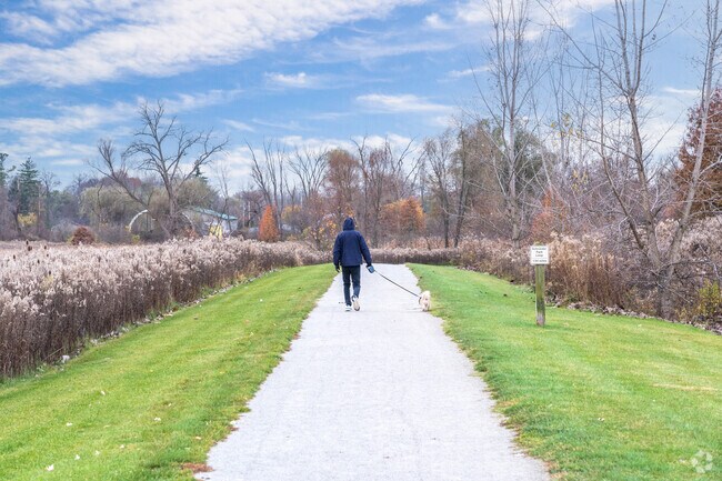 A man walks the Middle Branch Trail in Veterans Park near the Washington Square neighborhood.
