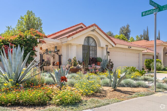 A small Spanish style home in CSU Bakersfield displays colorful drought-tolerant plants in their yard.