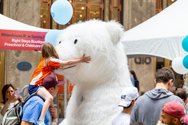 Children magnetize to stuffed characters at the Rittenhouse Row Spring Festival.