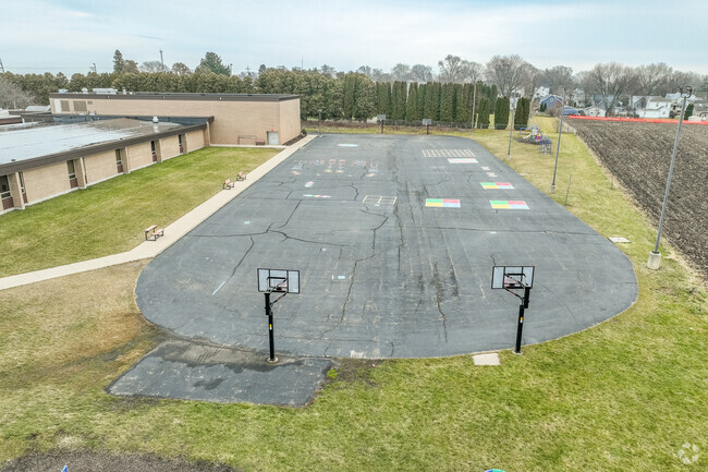Monroe Center School offers a small basketball court for students.