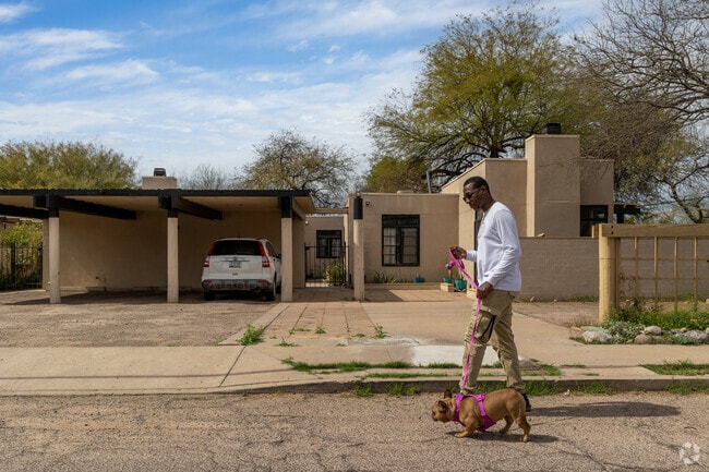 Locals walk their dogs through Hedrick Acres, where homes display many unique styles.