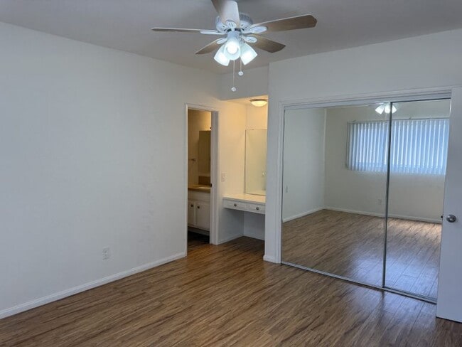Apt #5: Bedroom #1 with ensuite bathroom with shower, mirrored closets, and dressing area