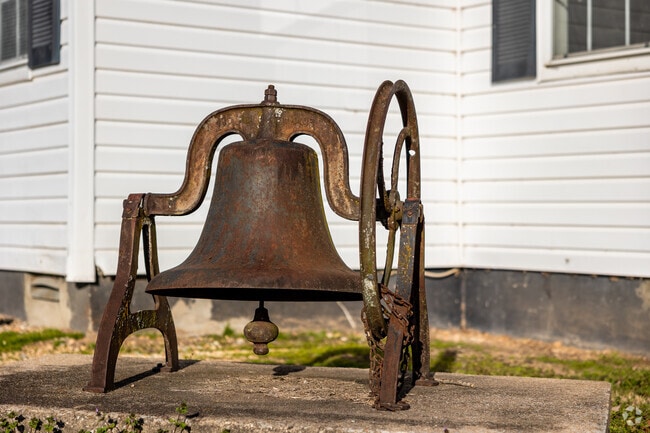 The bell from the Savoy Community Building sits outside the front entrance.