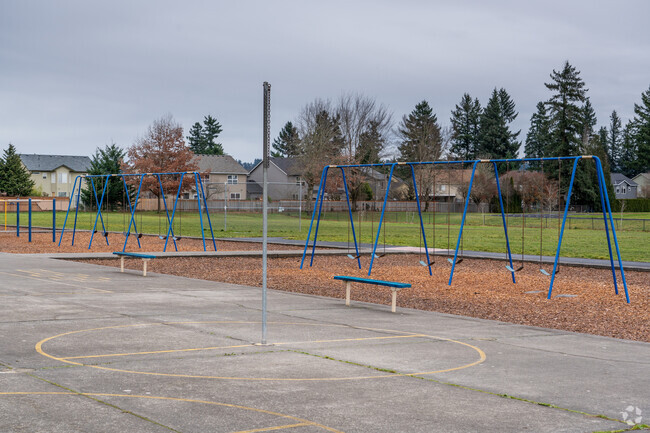 The playground at Illahee Elementary School features multiple swing sets.