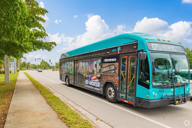 A colorful bus travels through La Mancha, providing reliable transportation for residents.