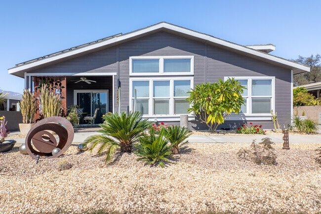 A modern manufactured home in Palm Desert Greens Country Club, featuring sleek design, spacious interiors, and breathtaking desert views within a vibrant 55+ community.
