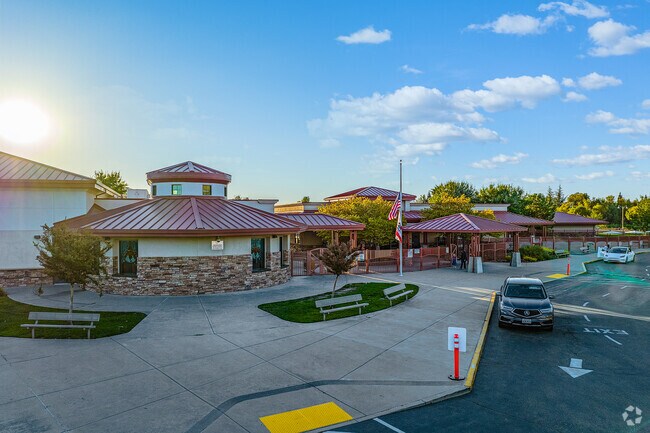 Sunsets over the red roof of Twelve Bridges Elementary School as children wrap up the day.