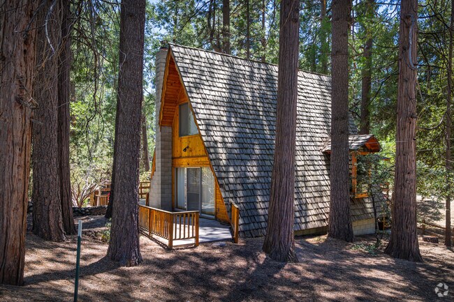 Classic A frame cabin sits in the woods of Pine Cove.