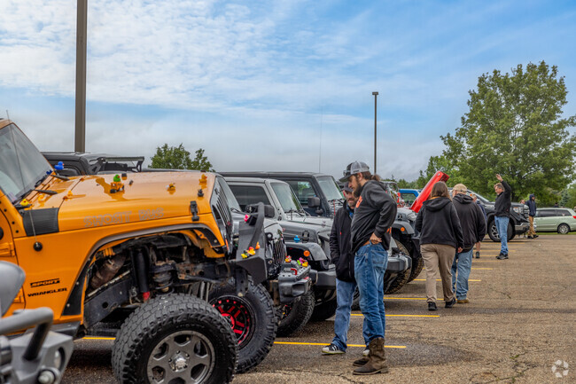 Jeep enthusiasts admire all the custom jeeps shown at the Hartville Jeep Fest.