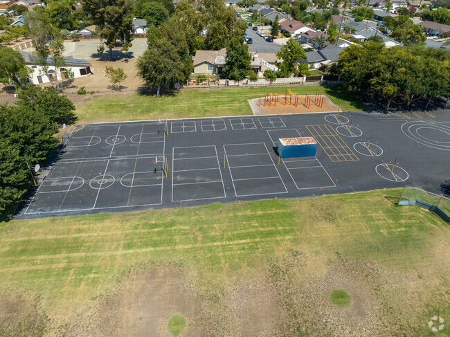 Blacktop play area with courts and playground at Rose Drive Elementary.