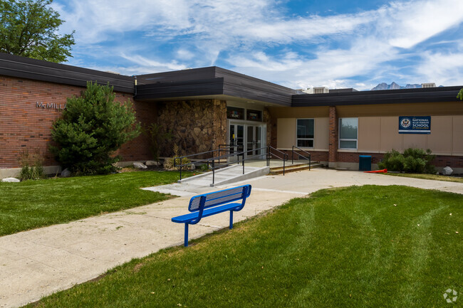 A blue bench sits near the entrance to McMillan Elementary School.