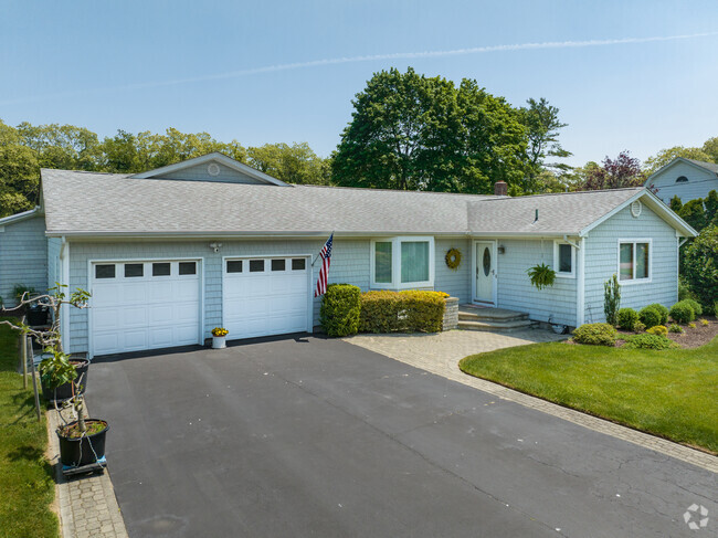 Lovely ranch style home in Moriches have dual garages for some homes.