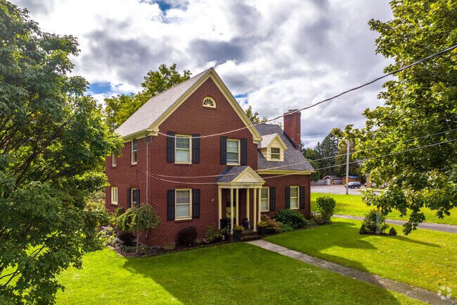 Cross-gabled roofs with brick chimneys add much charm to Solvay.