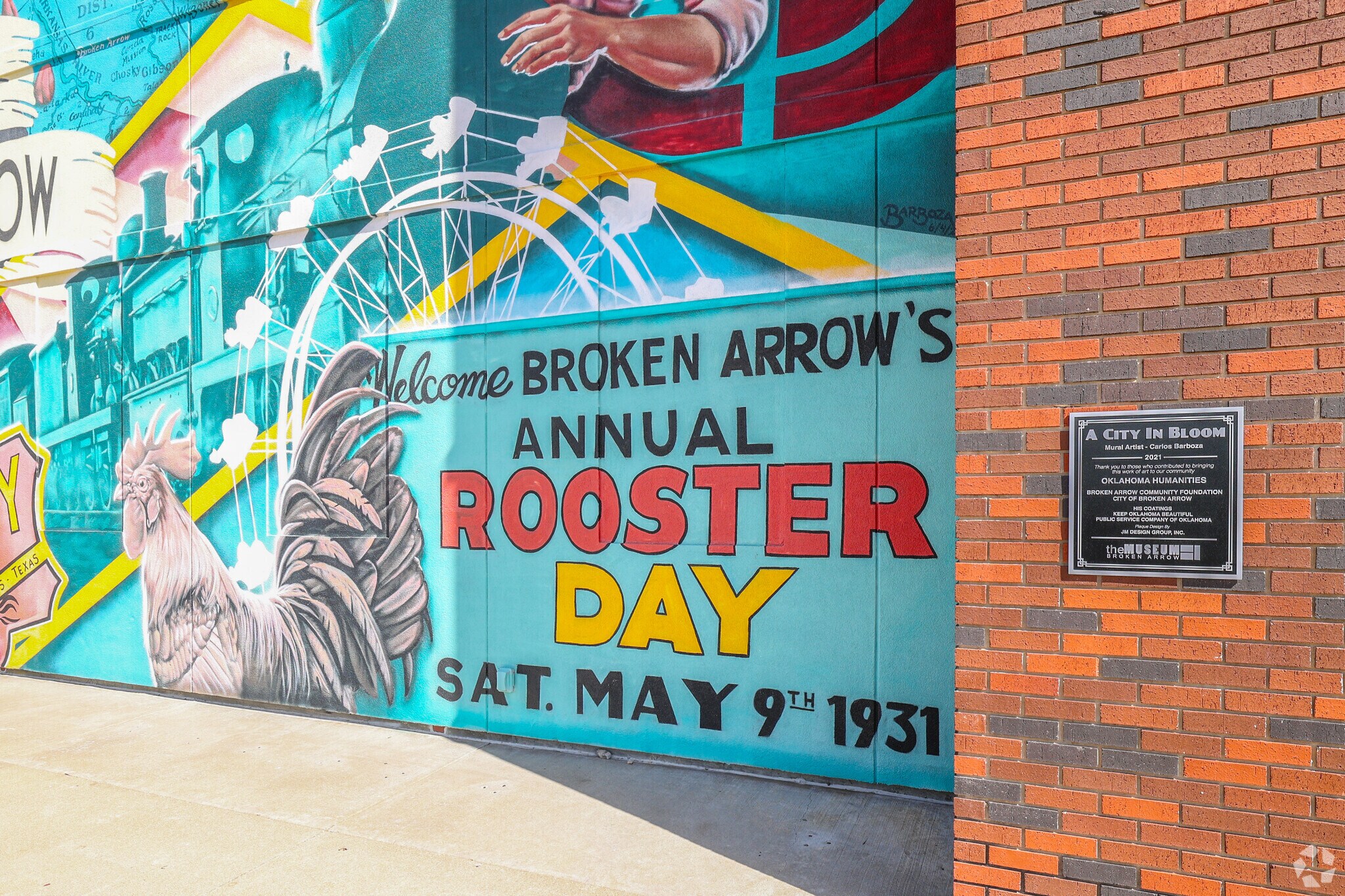 The City In Bloom mural in Broken Arrow pays tribute to Rooster Day festival, started in 1931.