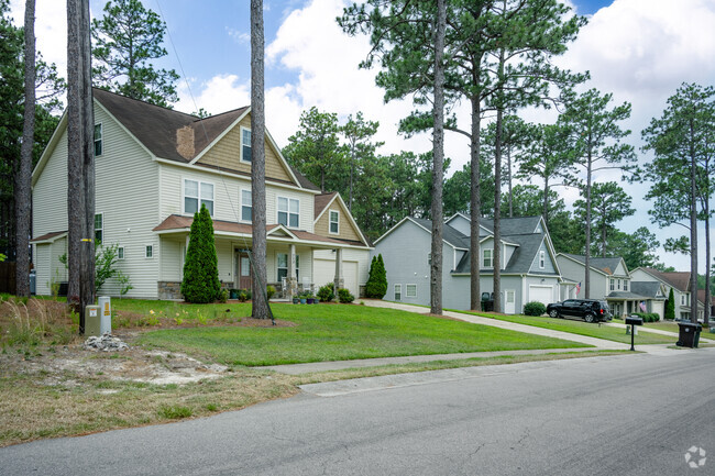 Larger homes surrounded by trees can be found in the Forest Hills neighborhood.