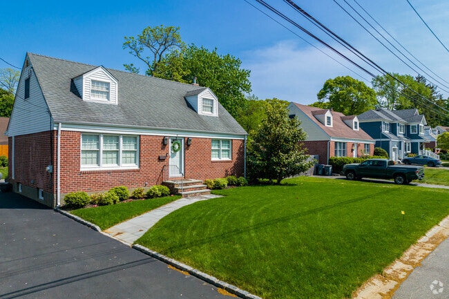 You will find many brick clad capes in East Northport.