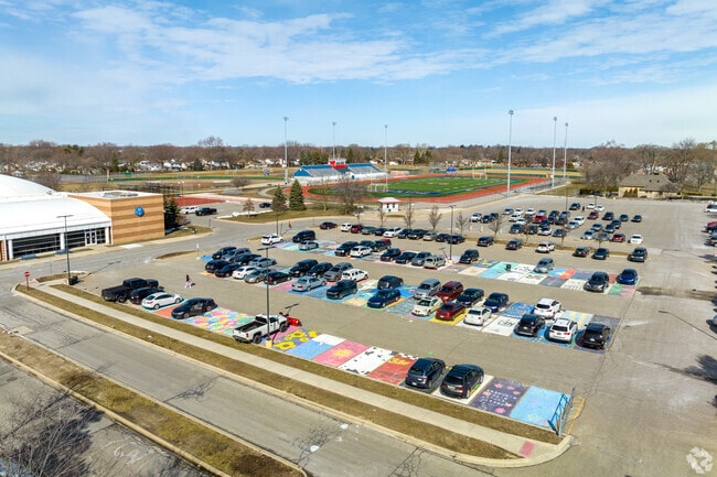 The students decorate the parking lot at Cousino High School.