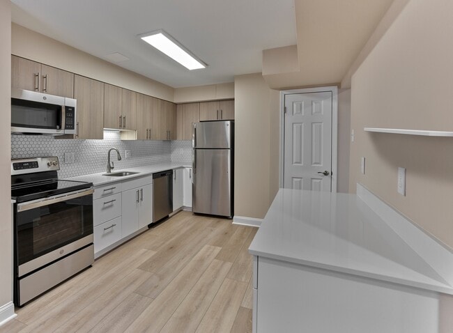 This beautifully updated kitchen, shown at our sister community Woods Edge, highlights the same sleek finishes coming soon to North Crossing Apartments — including stainless steel appliances, quartz countertops, and designer cabinetry.