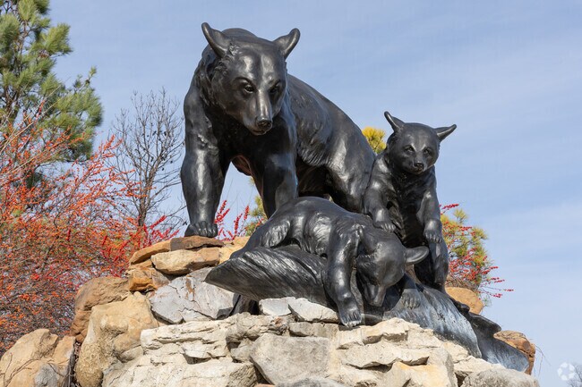 River Parks- BOK Plaza has a seating area surrounding a statue of a mother bear and her cubs