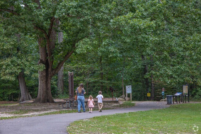 A family heads down one of the several walking trails at R. Garland Dodd Park