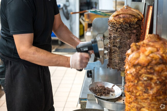 A local cook prepares a Mediterranean dish at Shawarma Bistro in Tuckahoe Village.