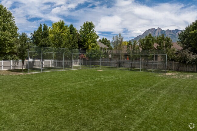 A baseball field at Woodstock Elementary School with green trees in the background.